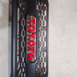 Toyota Hilux 2021 Raider grill with red lettering and top LED lights.